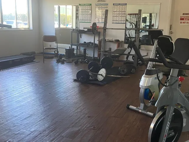 a living room with furniture and a book shelf