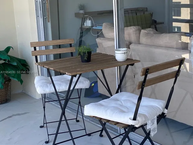 a view of a window and a room with wooden floor and door