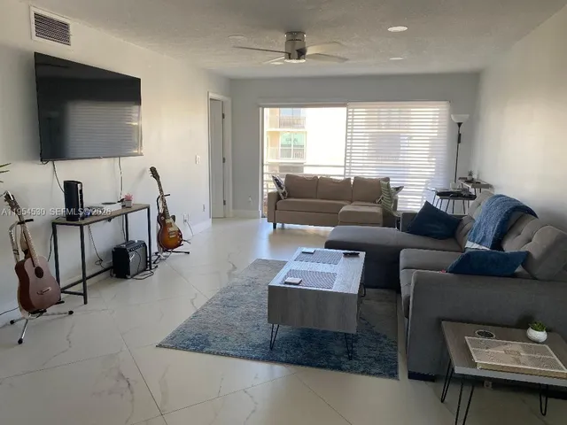 a view of a room with windows and furniture