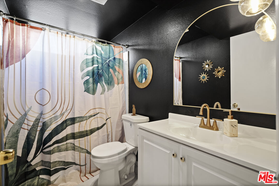 5245 Coldwater Canyon Avenue, Unit C Sherman Oaks, CA 91401 - Photo 19 of 55 a bathroom with a toilet a sink and a mirror