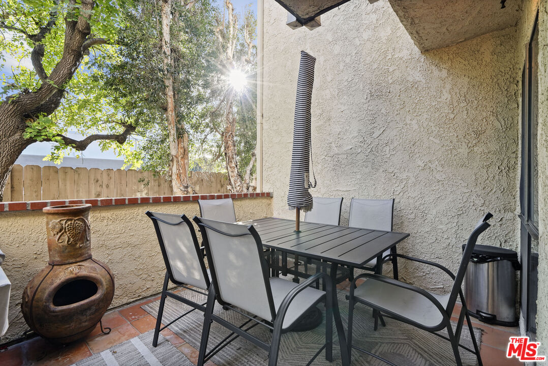 5245 Coldwater Canyon Avenue, Unit C Sherman Oaks, CA 91401 - Photo 20 of 55 a view of a patio with table and chairs and potted plants