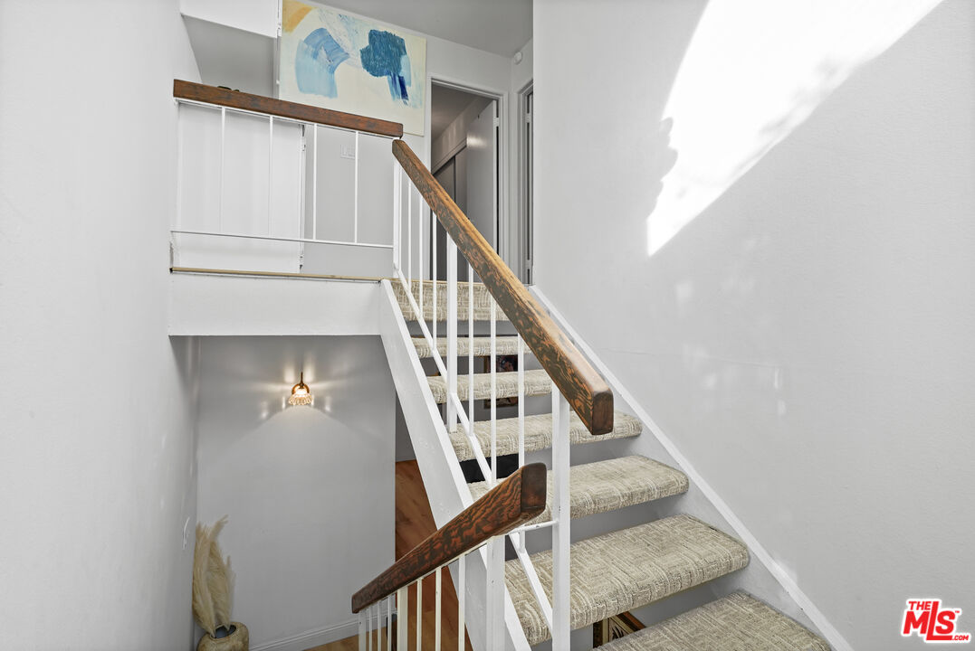 5245 Coldwater Canyon Avenue, Unit C Sherman Oaks, CA 91401 - Photo 25 of 55 a view of staircase with wooden floor and white walls
