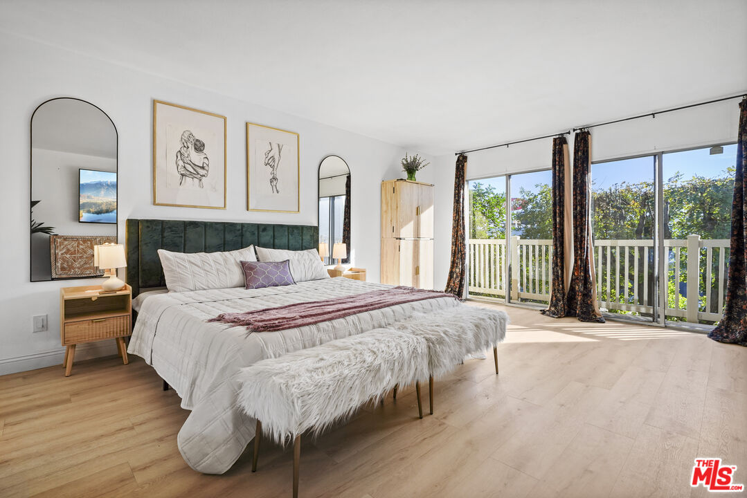5245 Coldwater Canyon Avenue, Unit C Sherman Oaks, CA 91401 - Photo 27 of 55 a bed sitting in a spacious bedroom next to a window