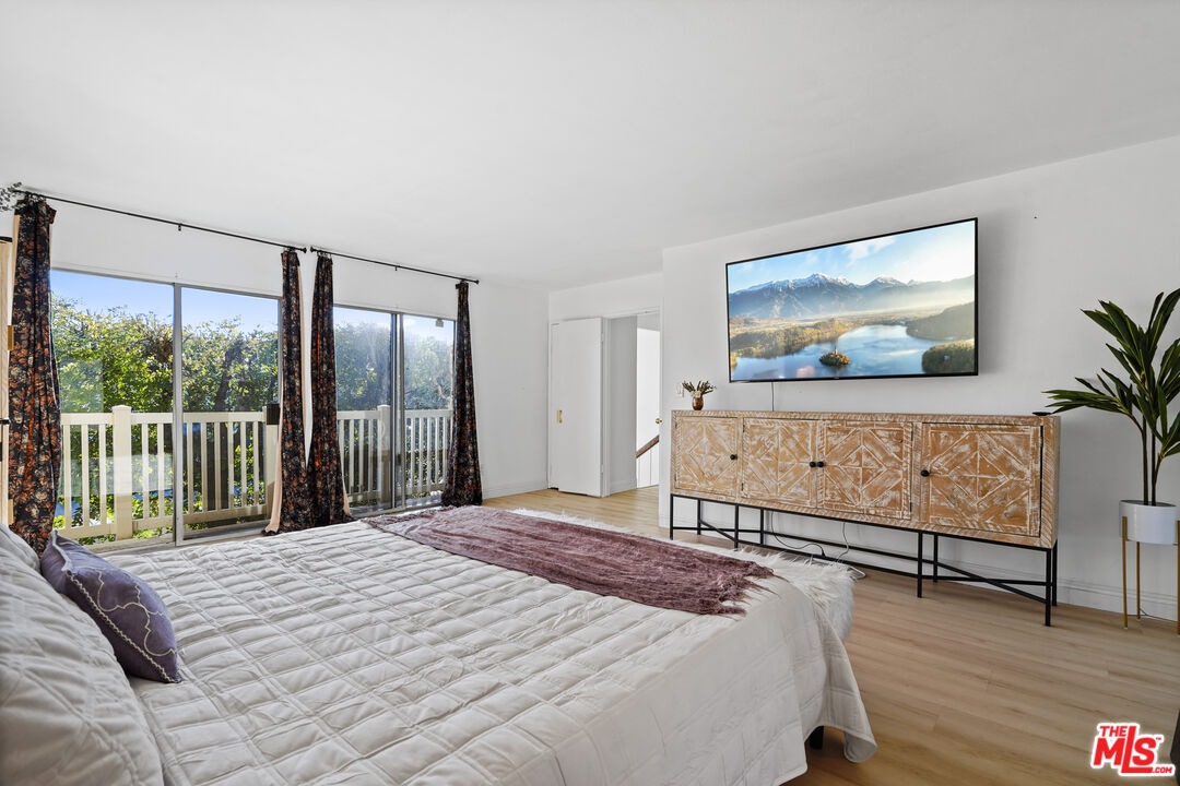 5245 Coldwater Canyon Avenue, Unit C Sherman Oaks, CA 91401 - Photo 28 of 55 a bedroom with a bed and a large window