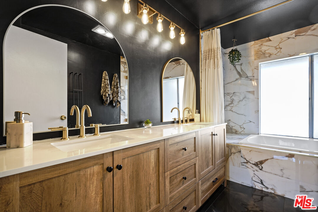 5245 Coldwater Canyon Avenue, Unit C Sherman Oaks, CA 91401 - Photo 30 of 55 a bathroom with a double vanity sink and a mirror