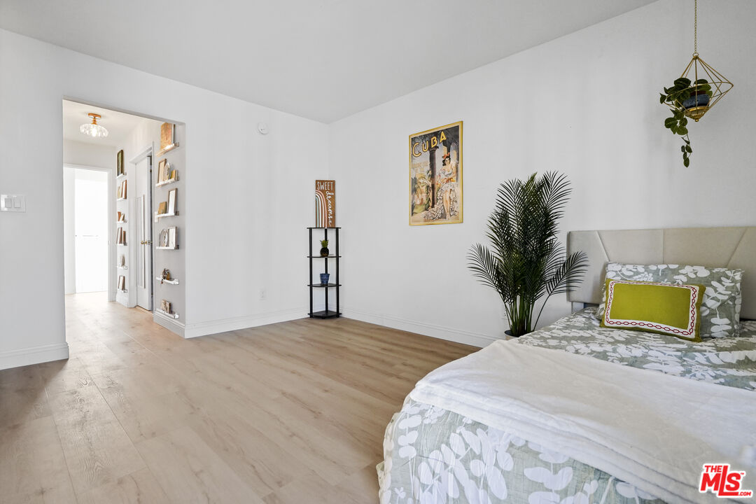 5245 Coldwater Canyon Avenue, Unit C Sherman Oaks, CA 91401 - Photo 36 of 55 a bedroom with a large bed and a potted plant