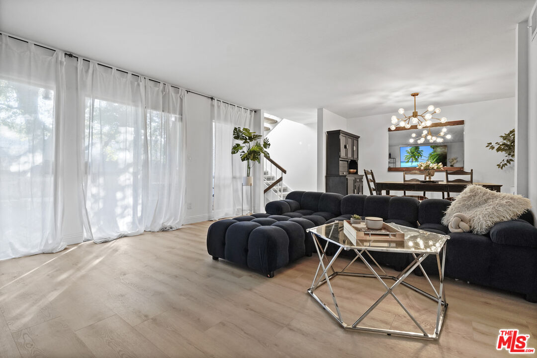 5245 Coldwater Canyon Avenue, Unit C Sherman Oaks, CA 91401 - Photo 7 of 55 a living room with furniture a chandelier and a window