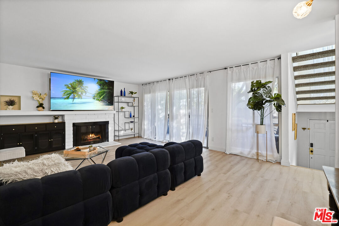 5245 Coldwater Canyon Avenue, Unit C Sherman Oaks, CA 91401 - Photo 8 of 55 a living room with furniture a fireplace and a flat screen tv