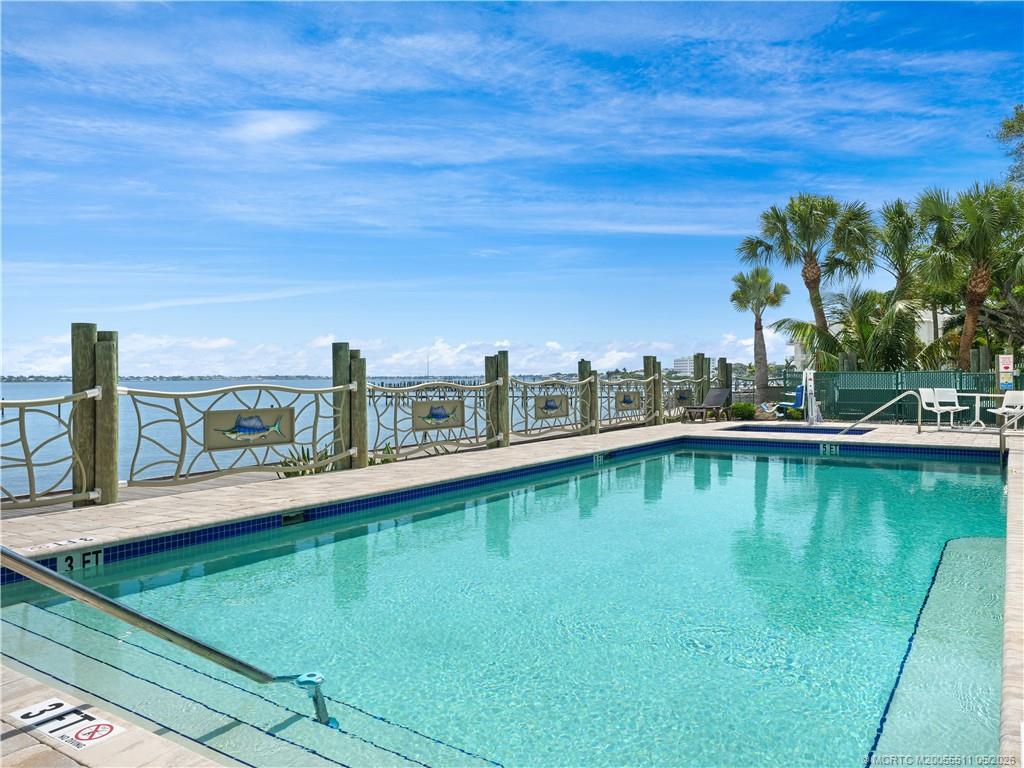 41 Southwest Seminole Street, Unit 208 Stuart, FL 34994 - Photo 3 of 46 a view of a swimming pool with an outdoor seating