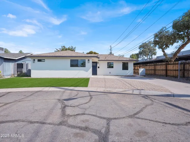a view of house in front of a house with a big yard