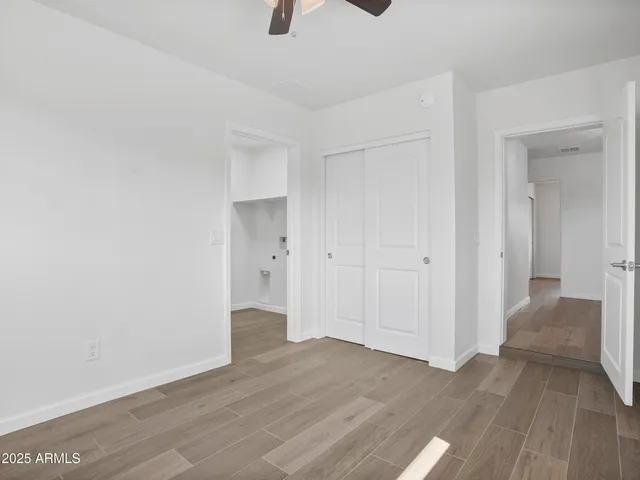 a bedroom with a bed and a painting on the wall