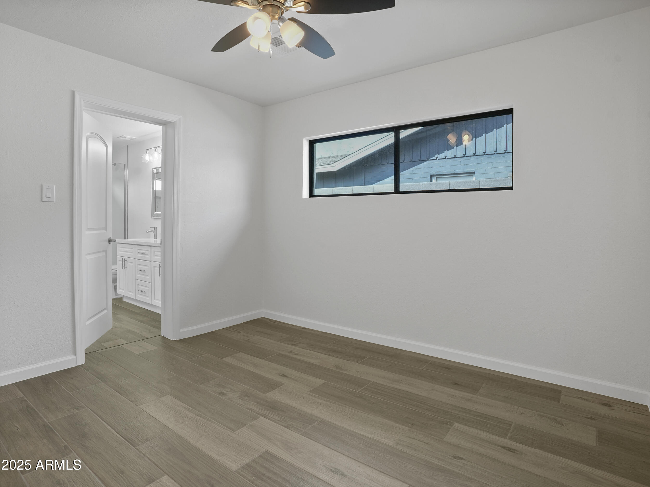 1046 East Elm Street Phoenix, AZ 85014 - Photo 17 of 31 an empty room with wooden floor and ceiling fan