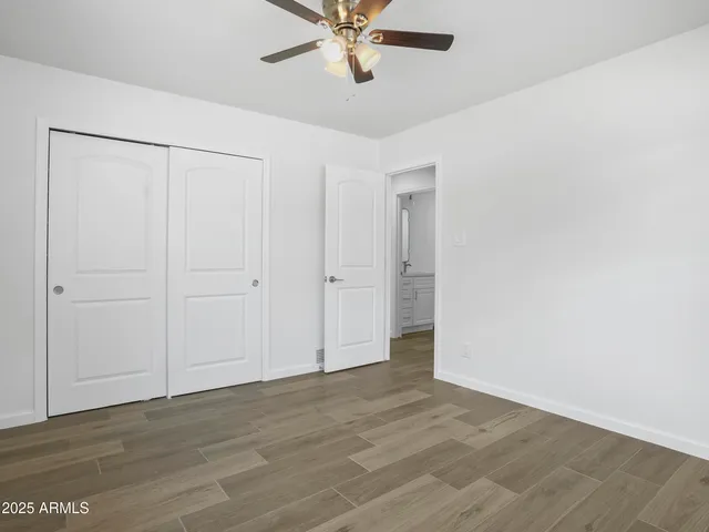 a bedroom with a bed and a painting on the wall