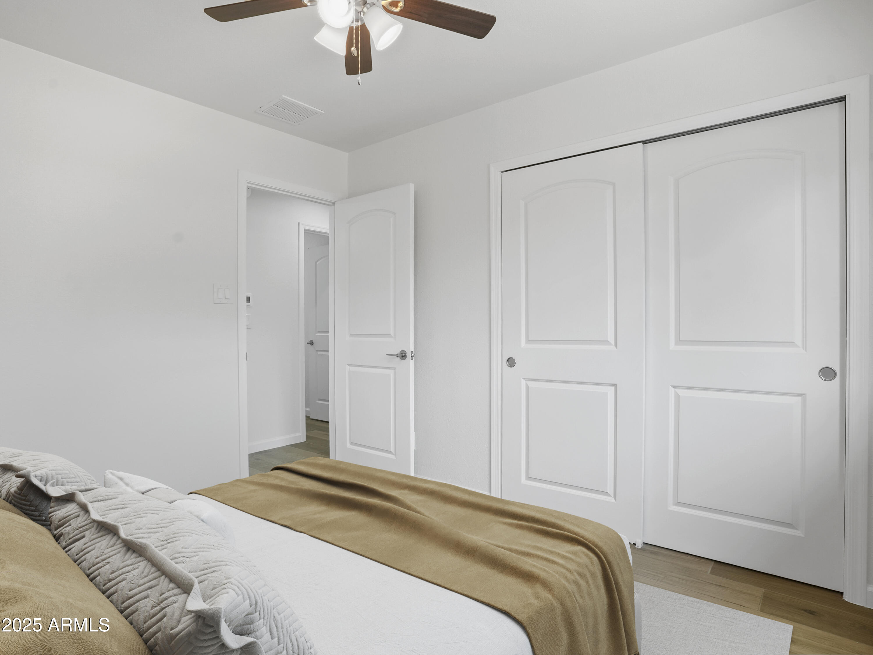 1046 East Elm Street Phoenix, AZ 85014 - Photo 25 of 31 a bedroom with a bed and a chandelier