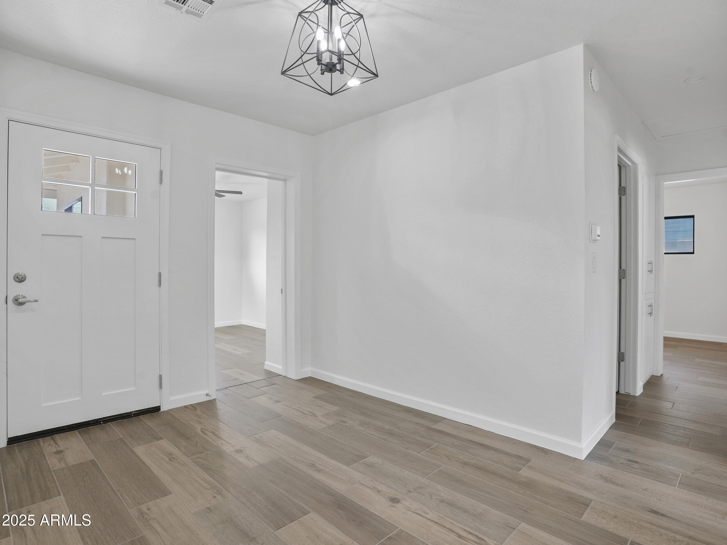 1046 East Elm Street Phoenix, AZ 85014 - Photo 4 of 31 a view of an empty room with wooden floor
