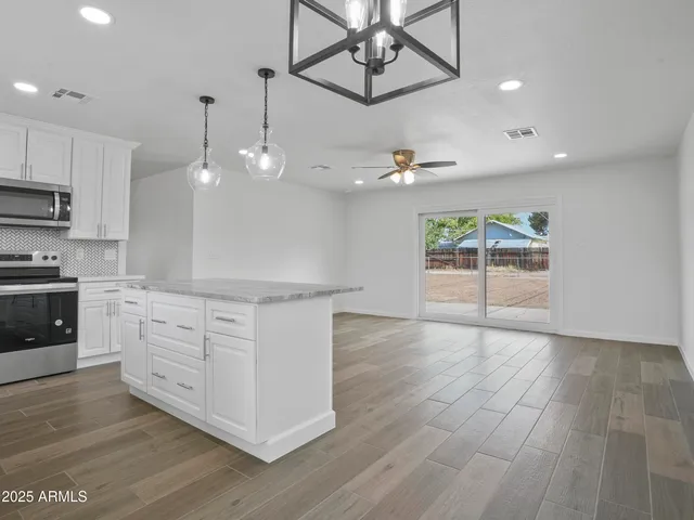 a view of a room with wooden floor
