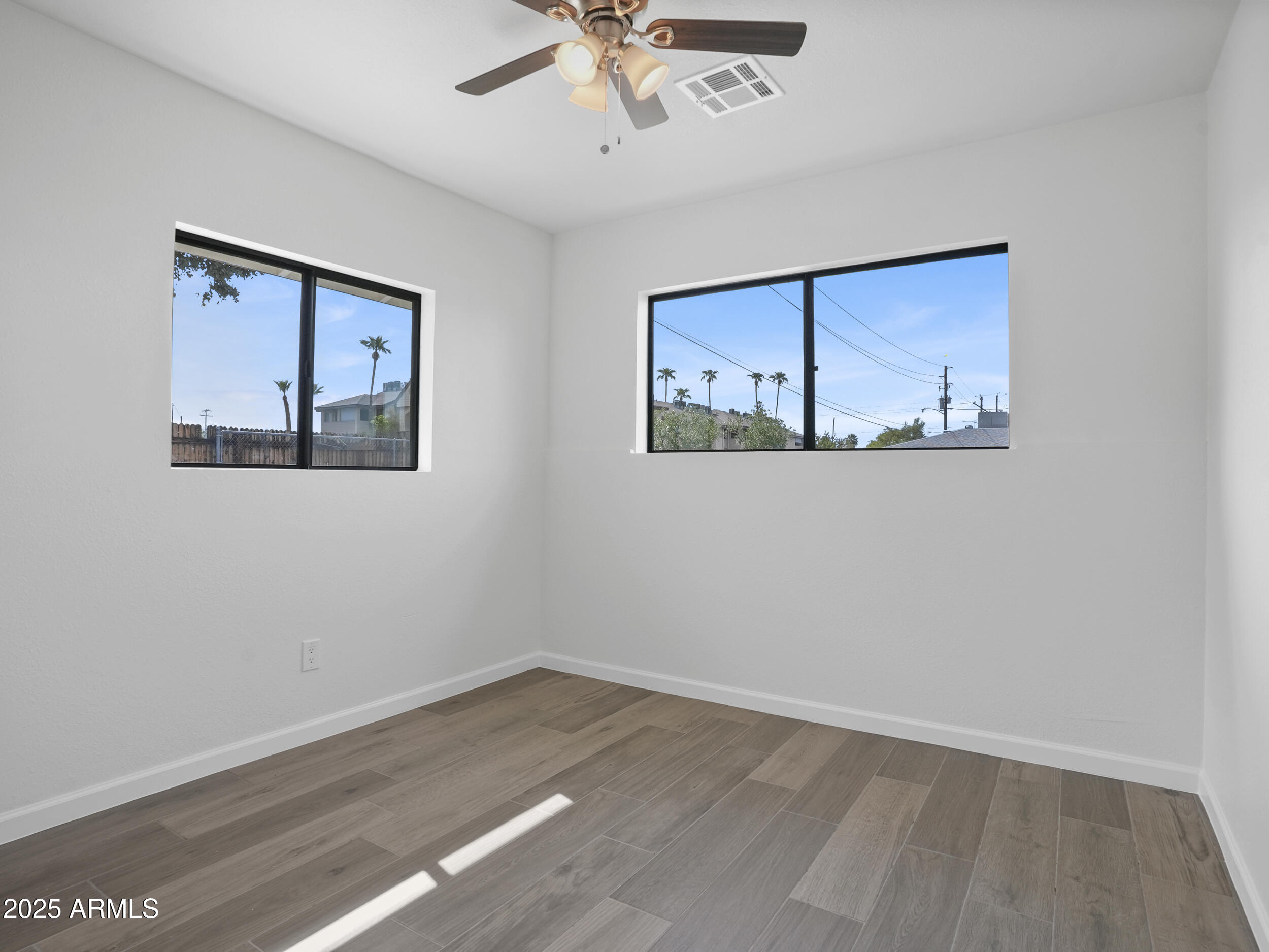 1046 East Elm Street Phoenix, AZ 85014 - Photo 10 of 31 a view of an empty room with a painting on the wall