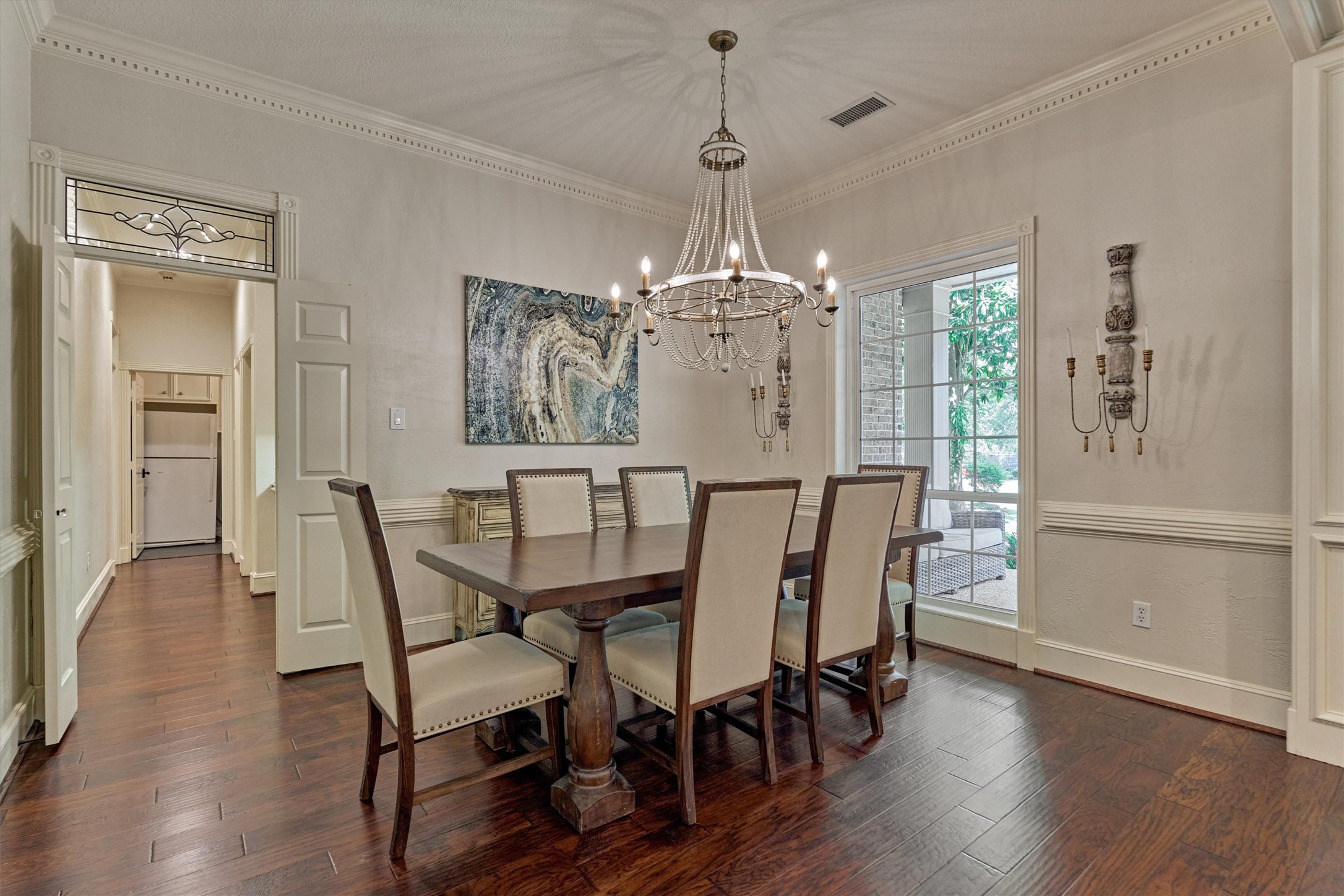 18 Treevine Court The Woodlands, TX 77381 - Photo 5 of 50 The formal dining room showcases classic elegance with a sparkling chandelier and a pass-through to the butler's pantry and kitchen.