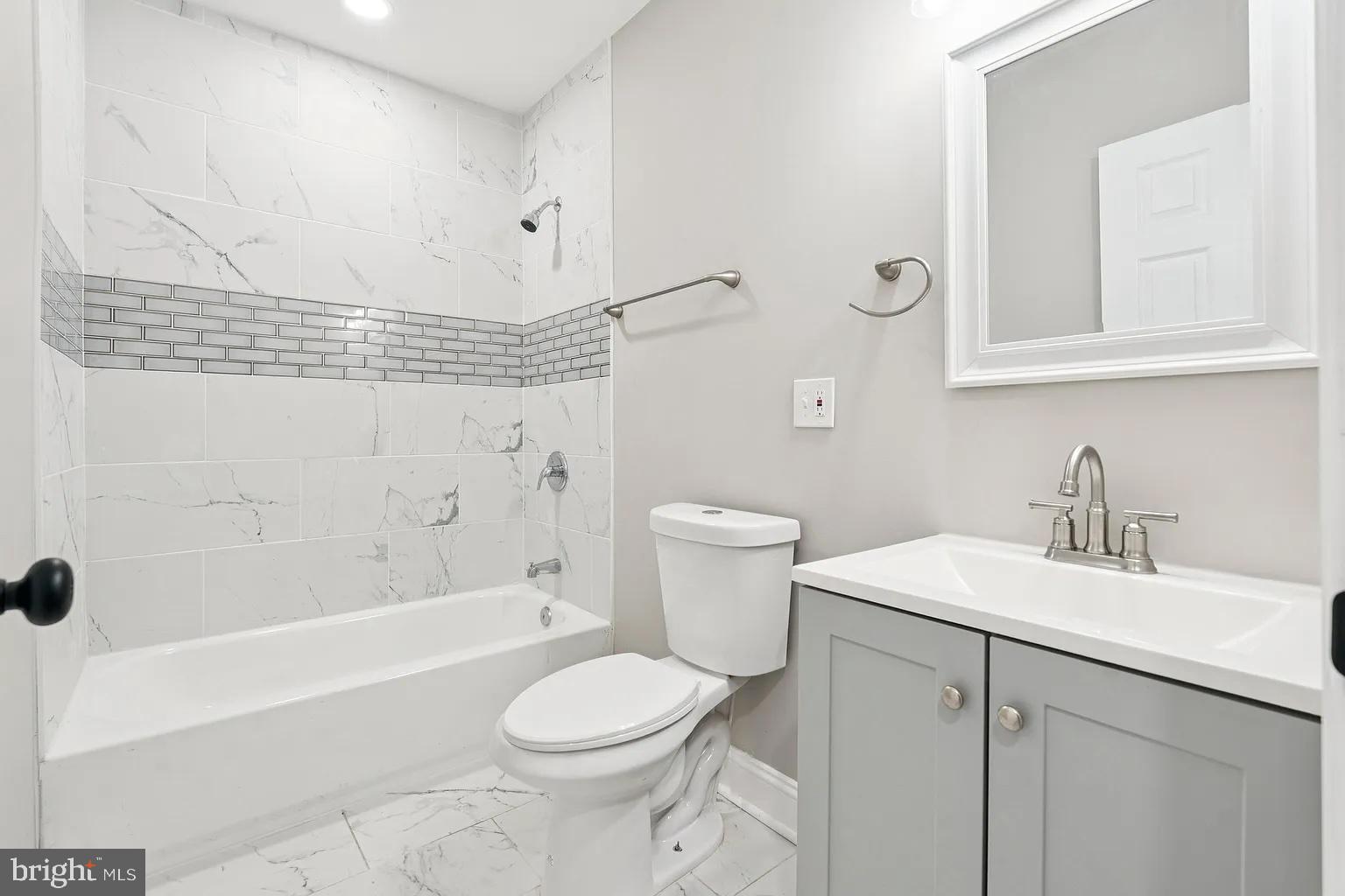 916 North Arlington Avenue, Unit 1 Baltimore, MD 21217 - Photo 13 of 14 a bathroom with a sink a toilet and shower