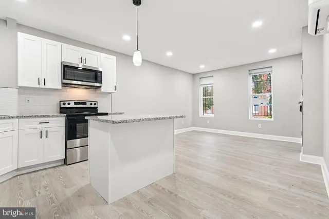 a kitchen with stainless steel appliances granite countertop a stove and a refrigerator