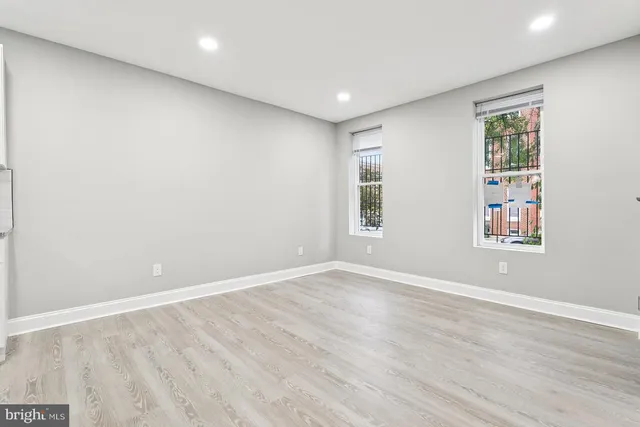 an empty room with windows and closet