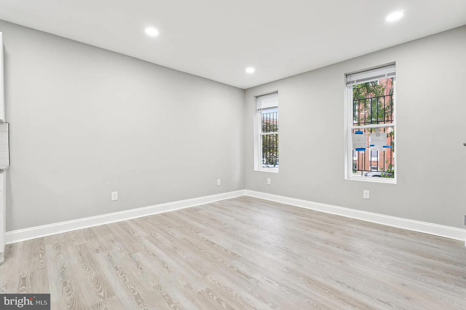 916 North Arlington Avenue, Unit 1 Baltimore, MD 21217 - Photo 5 of 14 an empty room with windows and closet