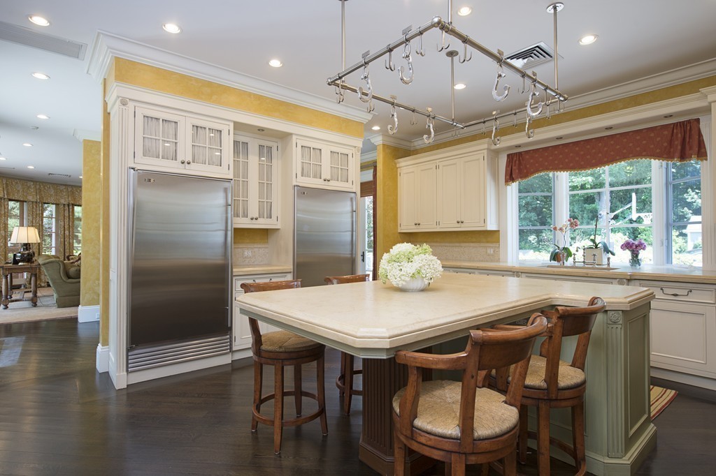45 Young Road Weston, MA 02493 - Photo 14 of 18 a kitchen with stainless steel appliances granite countertop a dining table chairs and wooden floor