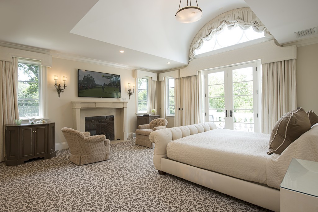 45 Young Road Weston, MA 02493 - Photo 4 of 18 a bedroom with a bed and a fireplace