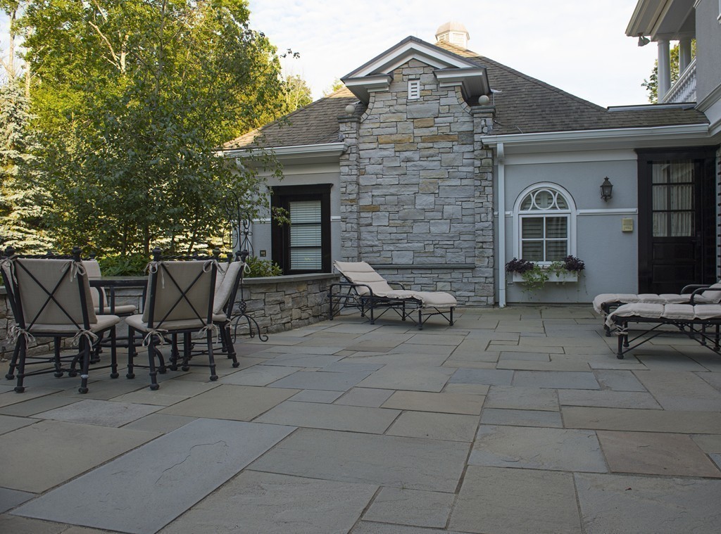 45 Young Road Weston, MA 02493 - Photo 9 of 18 a view of a patio with table and chairs and a barbeque