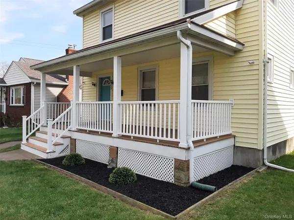 a view of a house with a yard and deck