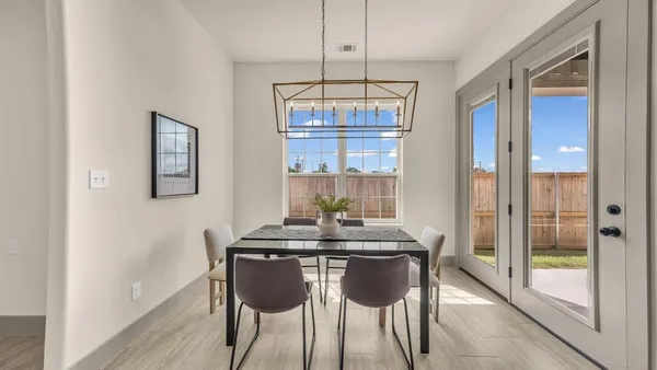 a large kitchen with kitchen island a large counter space a sink stainless steel appliances and cabinets