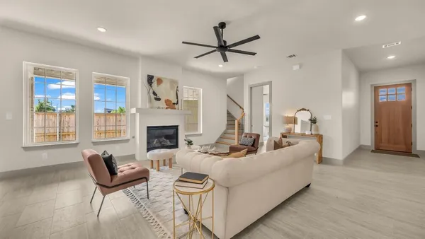 a living room with furniture fireplace and window