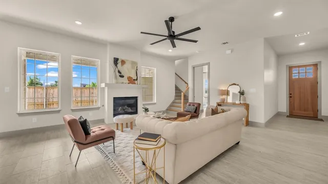 a living room with furniture fireplace and window