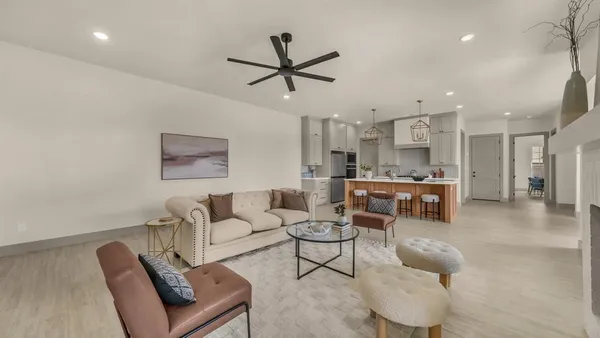 a living room with furniture and kitchen view