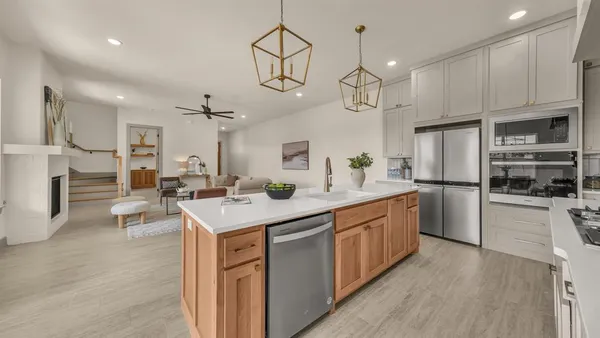 a kitchen with stainless steel appliances a sink stove and refrigerator