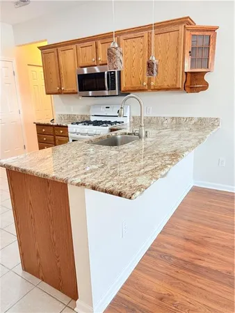 a kitchen with stainless steel appliances granite countertop a sink and a microwave