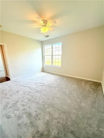 an empty room with a empty space and windows