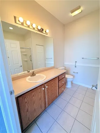 a spacious bathroom with a double vanity sink mirror and toilet
