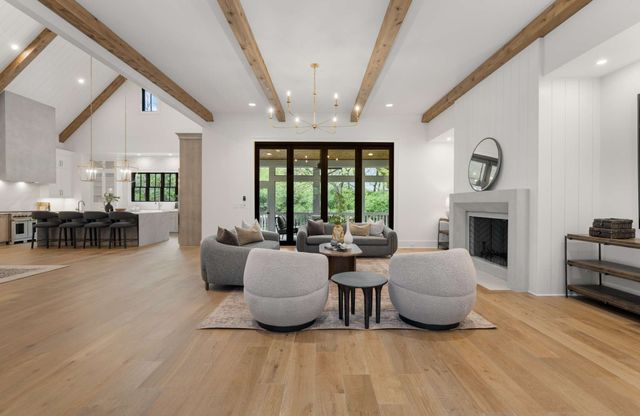 a living room with lots of furniture and view of kitchen