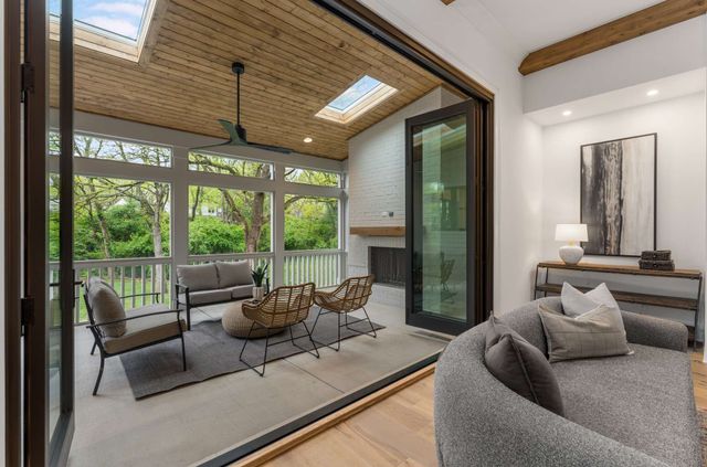 a kitchen with kitchen island granite countertop a table chairs sink and cabinets