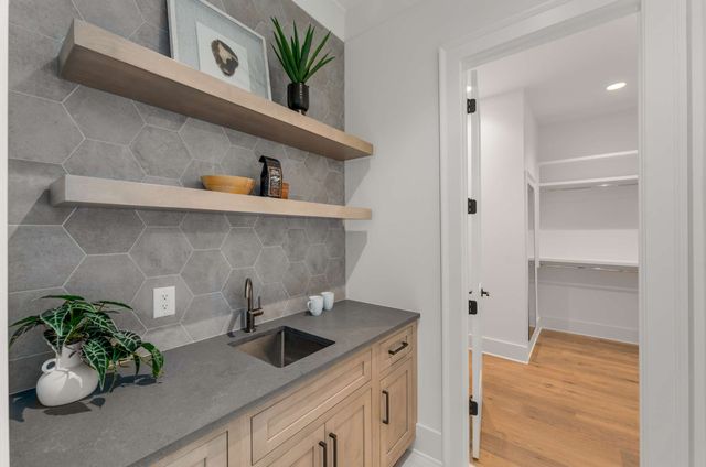 a view of empty room with wooden floor and ceiling fan