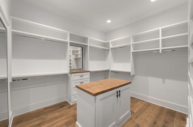 a large bedroom with a bed and a large window