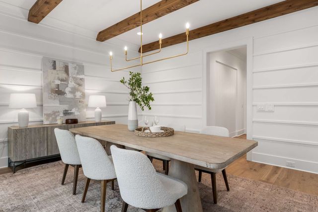 a living room with furniture a chandelier and a window