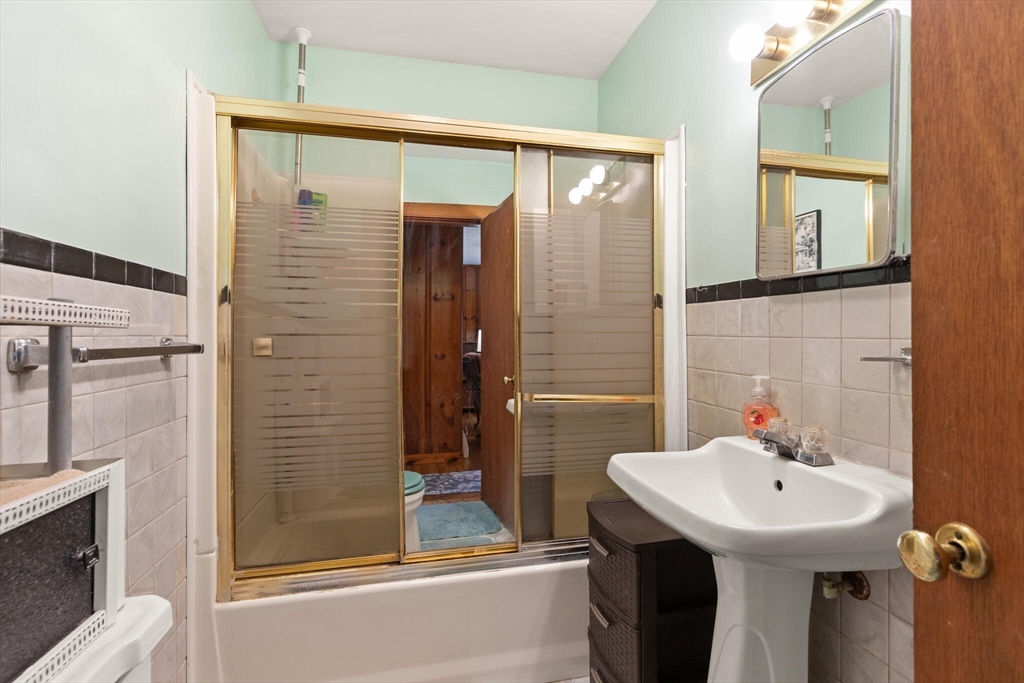 4 Vernon Street Ayer, MA 01432 - Photo 15 of 23 a bathroom with a sink a mirror and a shower