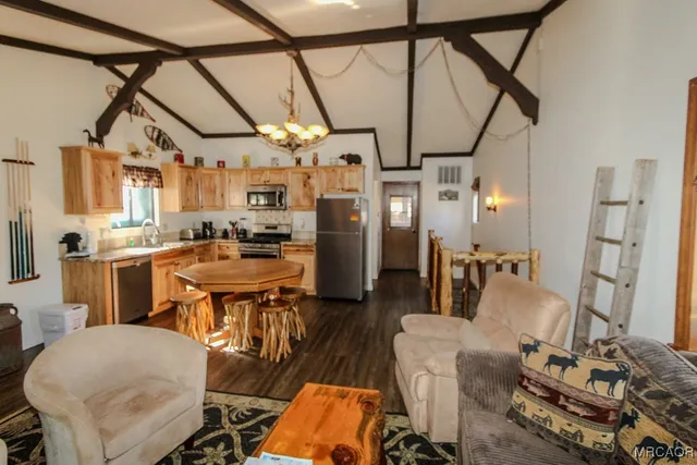 a kitchen with stainless steel appliances kitchen island granite countertop furniture and a refrigerator