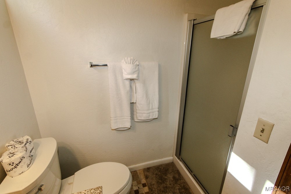 664 Knight Avenue Big Bear Lake, CA 92315 - Photo 16 of 35 a bathroom with a toilet and a shower
