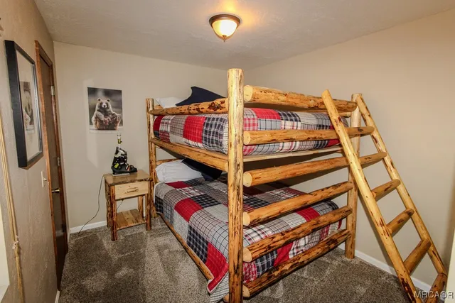 a bedroom with bunk bed and a window