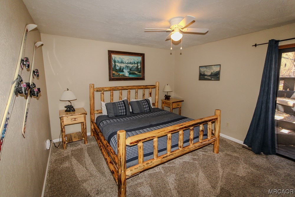 664 Knight Avenue Big Bear Lake, CA 92315 - Photo 27 of 35 a bedroom with a bed and a chandelier