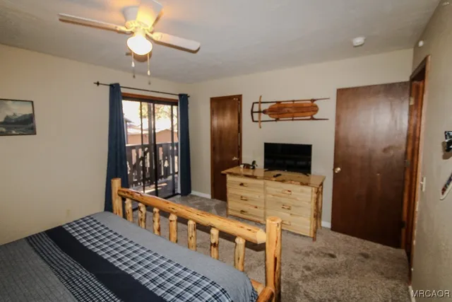 a bedroom with bed and a chandelier