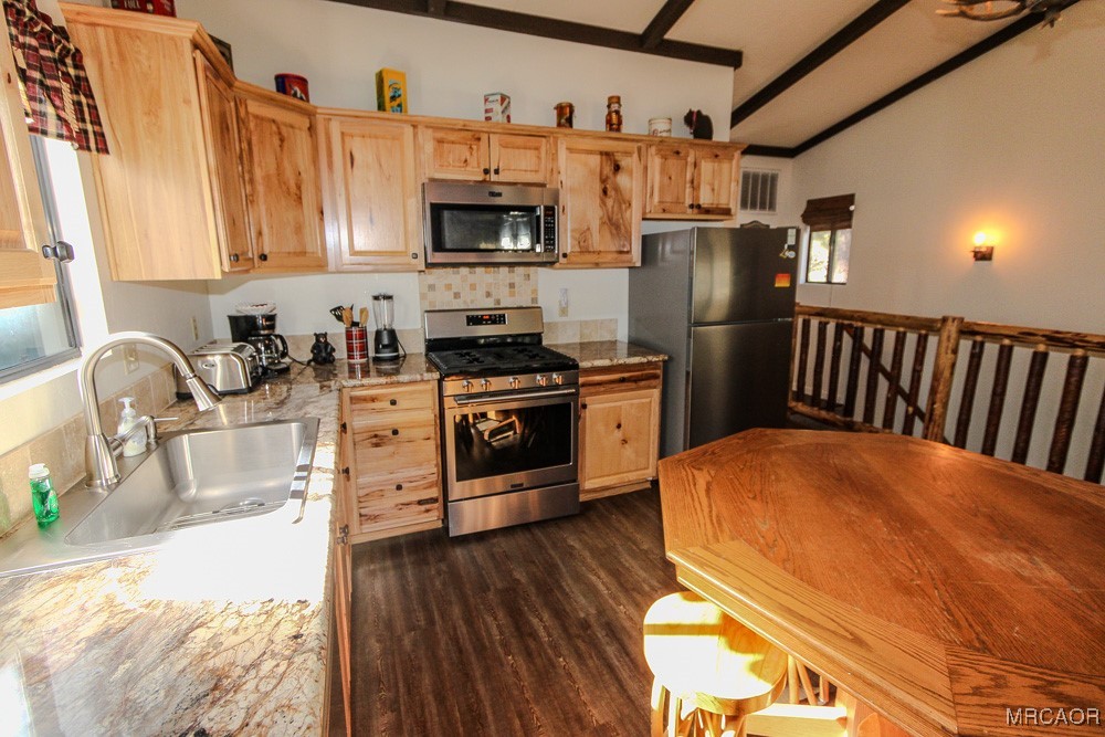 664 Knight Avenue Big Bear Lake, CA 92315 - Photo 6 of 35 a kitchen with stainless steel appliances a microwave a stove a sink dishwasher a refrigerator with a dining table and chairs